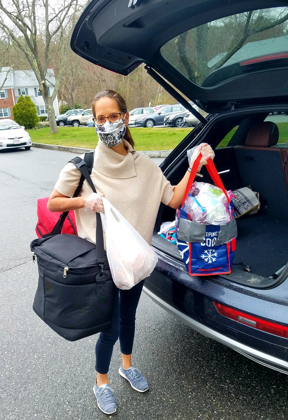 volunteer Meals on Wheels driver standing next to her car