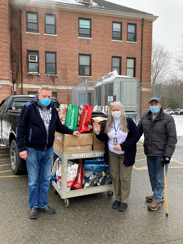 Volunteers delivering hand-crafted items to a non-profit partner agency