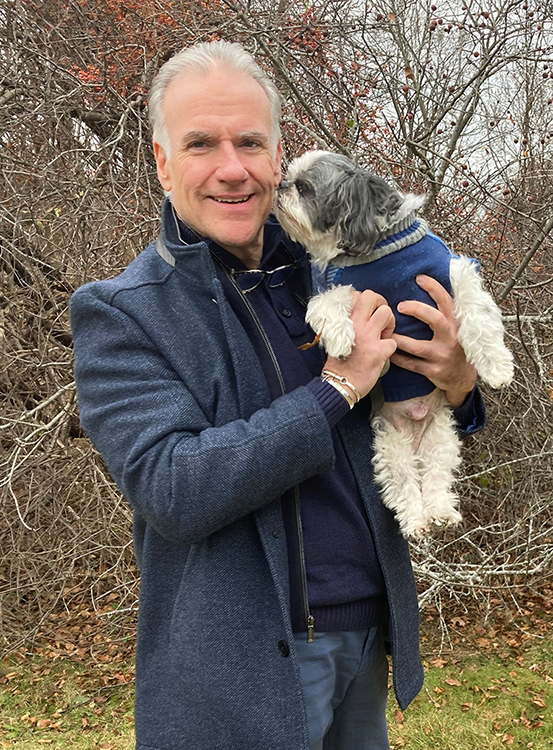 A STAY pet services volunteer holding a friendly dog