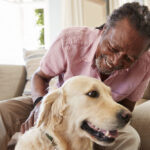 volunteer petting a dog